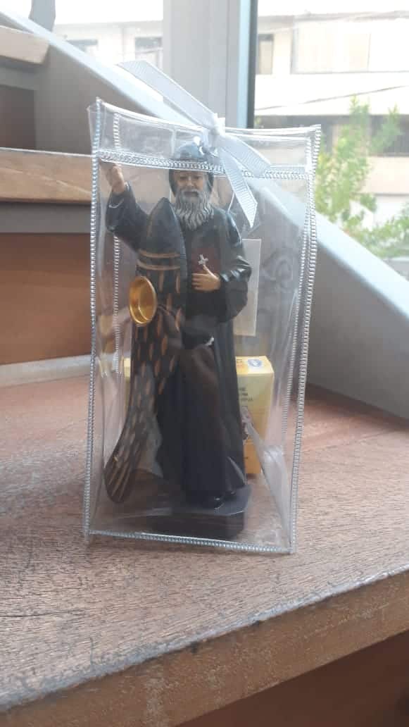 Mar Charbel statue with candle carrier and candle carrier